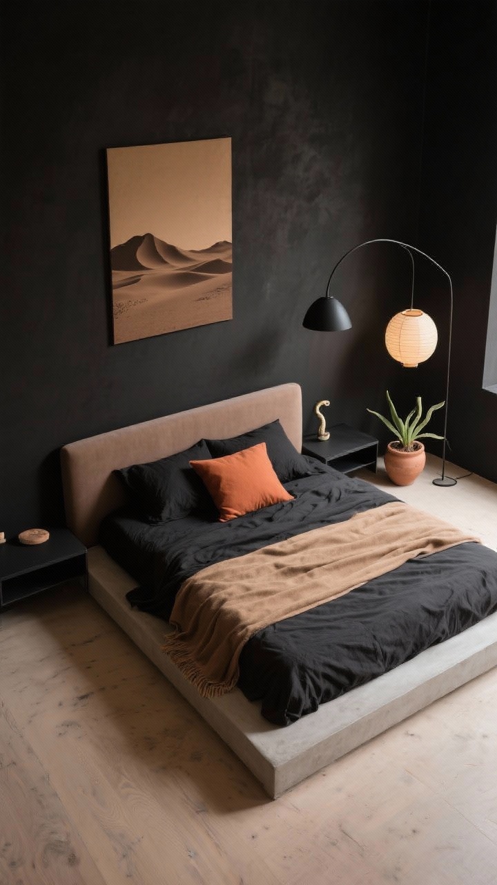Wide overhead shot: Desert Night Minimalism bedroom layout with soft black walls with brown undertones and a sandy microcement (or pale oak) floor for lightness. A low platform bed with a slim upholstered headboard in warm taupe holds monochrome tactile bedding: black linen duvet, camel throw, and a single terracotta lumbar pillow. A floating black shelf replaces nightstands, kept sparse. Sculptural lighting: a matte black arc lamp in the corner and a paper lantern pendant diffusing warm light. On the wall, a single oversized desert silhouette art in sepia tones; a clay planter with a snake plant near the bed. Palette of soft black, taupe, camel, terracotta, sand. Photorealistic, serene minimalism.