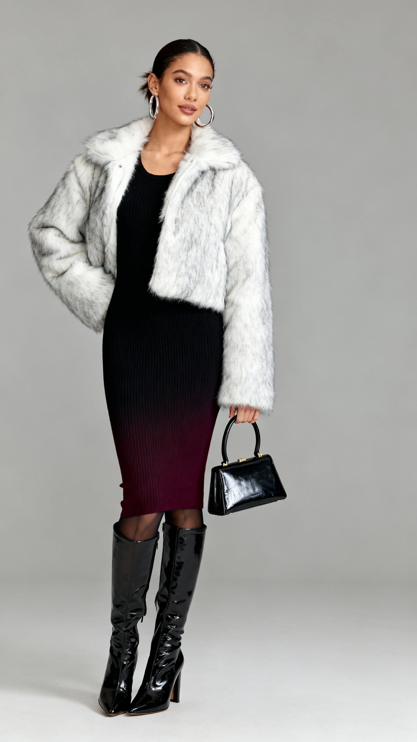 Studio fashion photo of a woman wearing a cropped faux fur coat (white or silver-gray), a bodycon knit midi dress (charcoal/black/deep wine), over-the-knee heeled boots (matte or patent), chunky hoop earrings, a structured mini top-handle bag, and sheer thermal tights; neutral gray background, soft studio lighting, professional natural pose, clean composition, high quality.