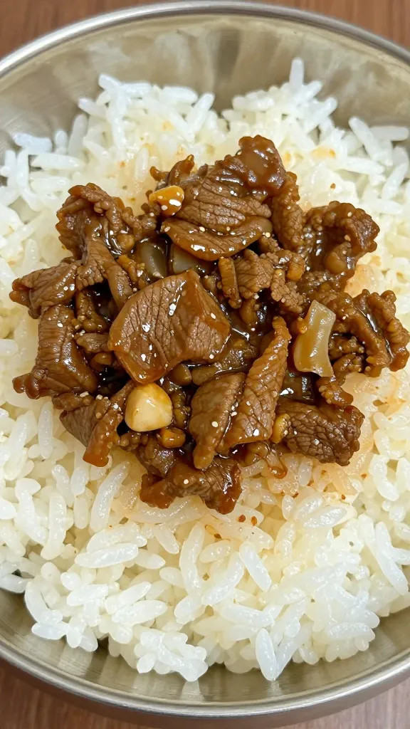 closeup bowl of Korean beef over fluffy white rice
